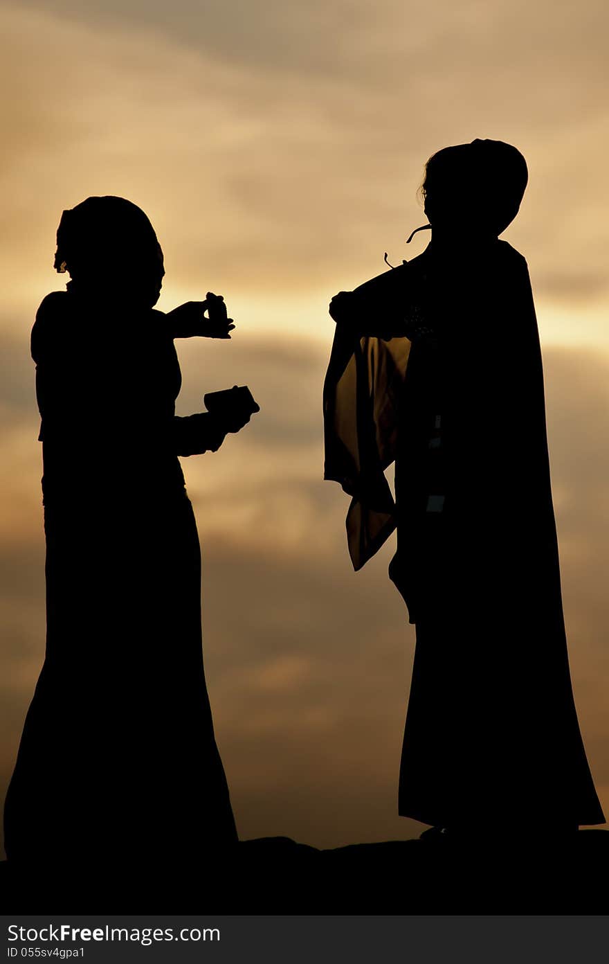 Arab women in conversation at sunset. Arab women in conversation at sunset