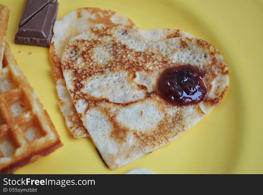 Heart-shaped pancakes with raspberry jam. A perfect breakfast for Valentine's Day.