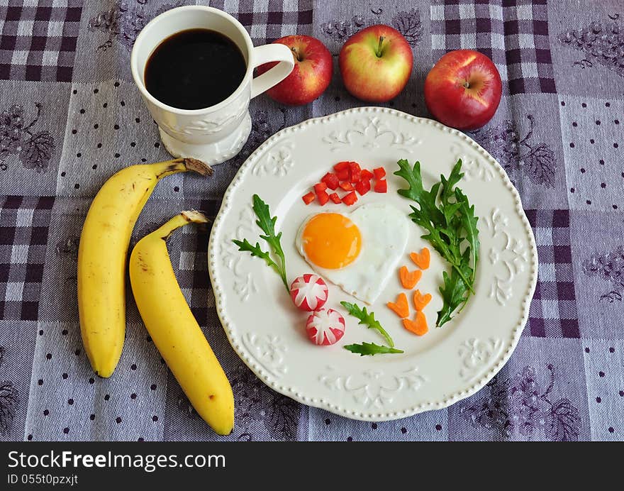 Heart shaped fried egg on beautiful plate. Healthy breakfast.