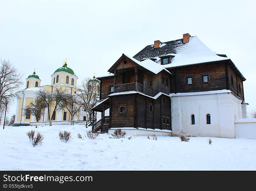 The wooden house and beautiful church in winter in Ukraine