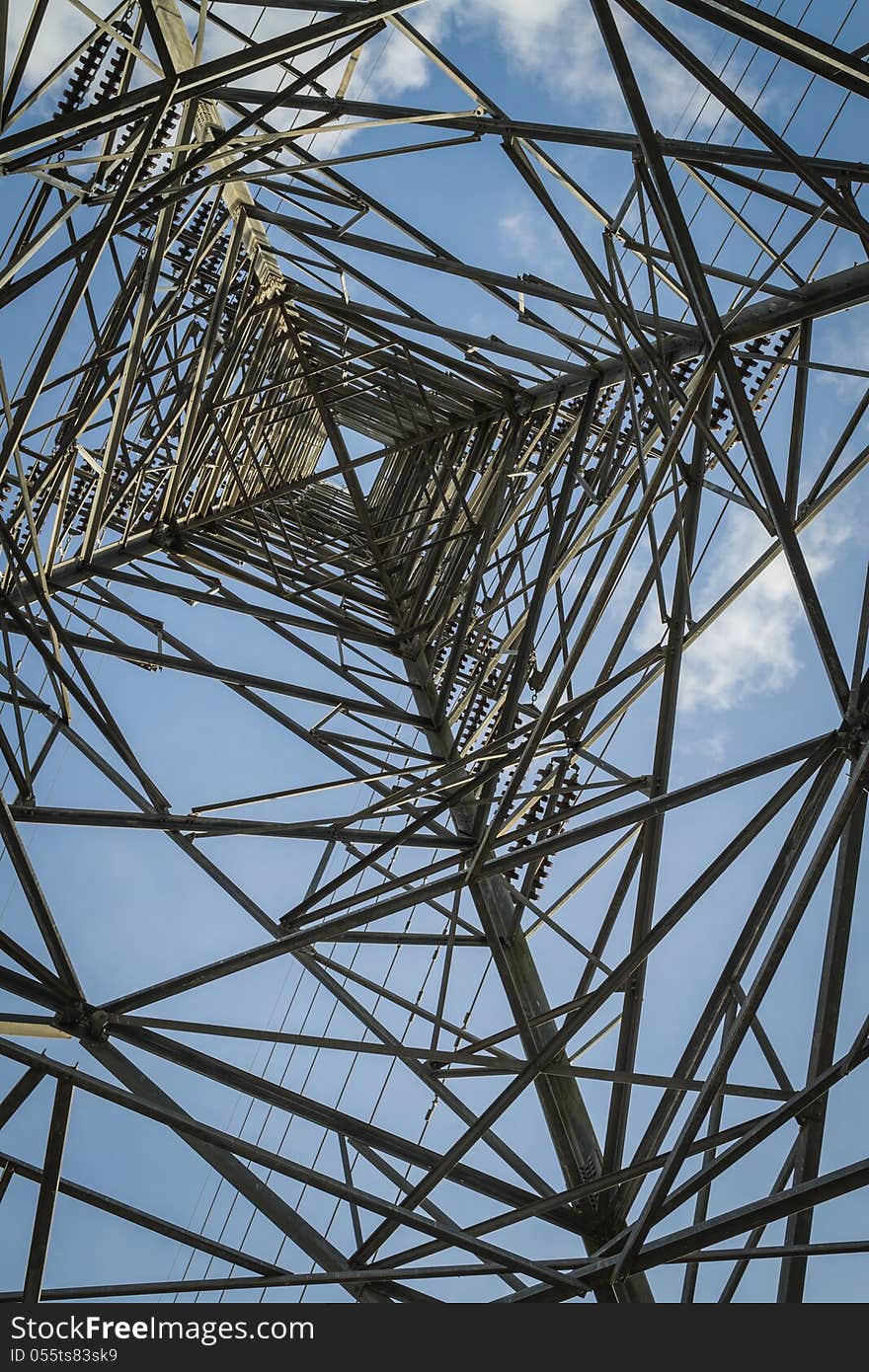 High- voltage tower with blue sky view from inside. High- voltage tower with blue sky view from inside