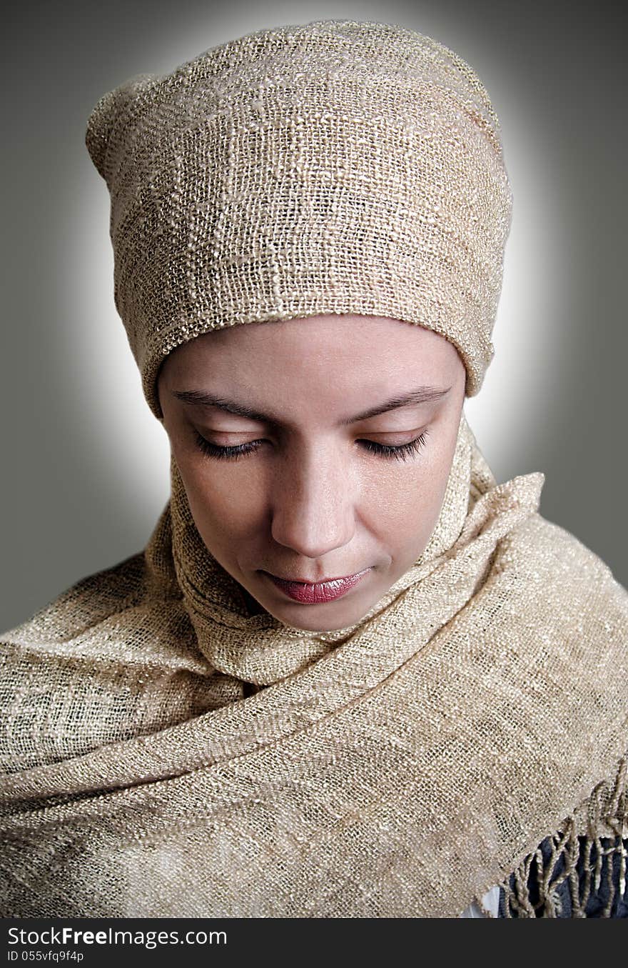 Close-up of a girl in a scarf looked down