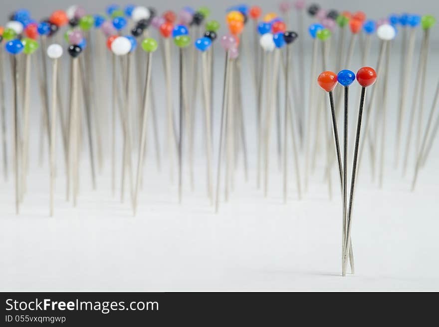 Different colored pins standing with background