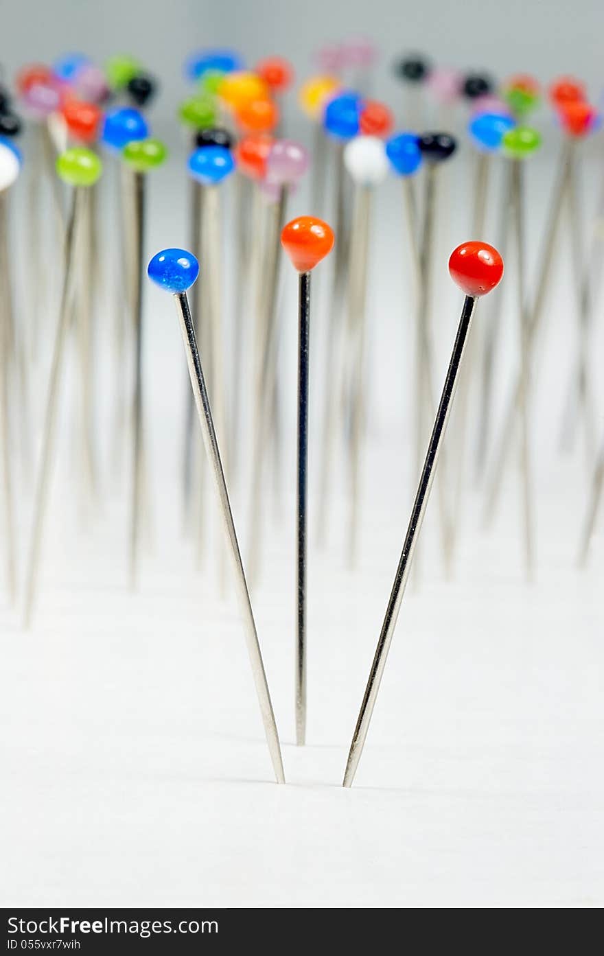 Different colored pins standing with background