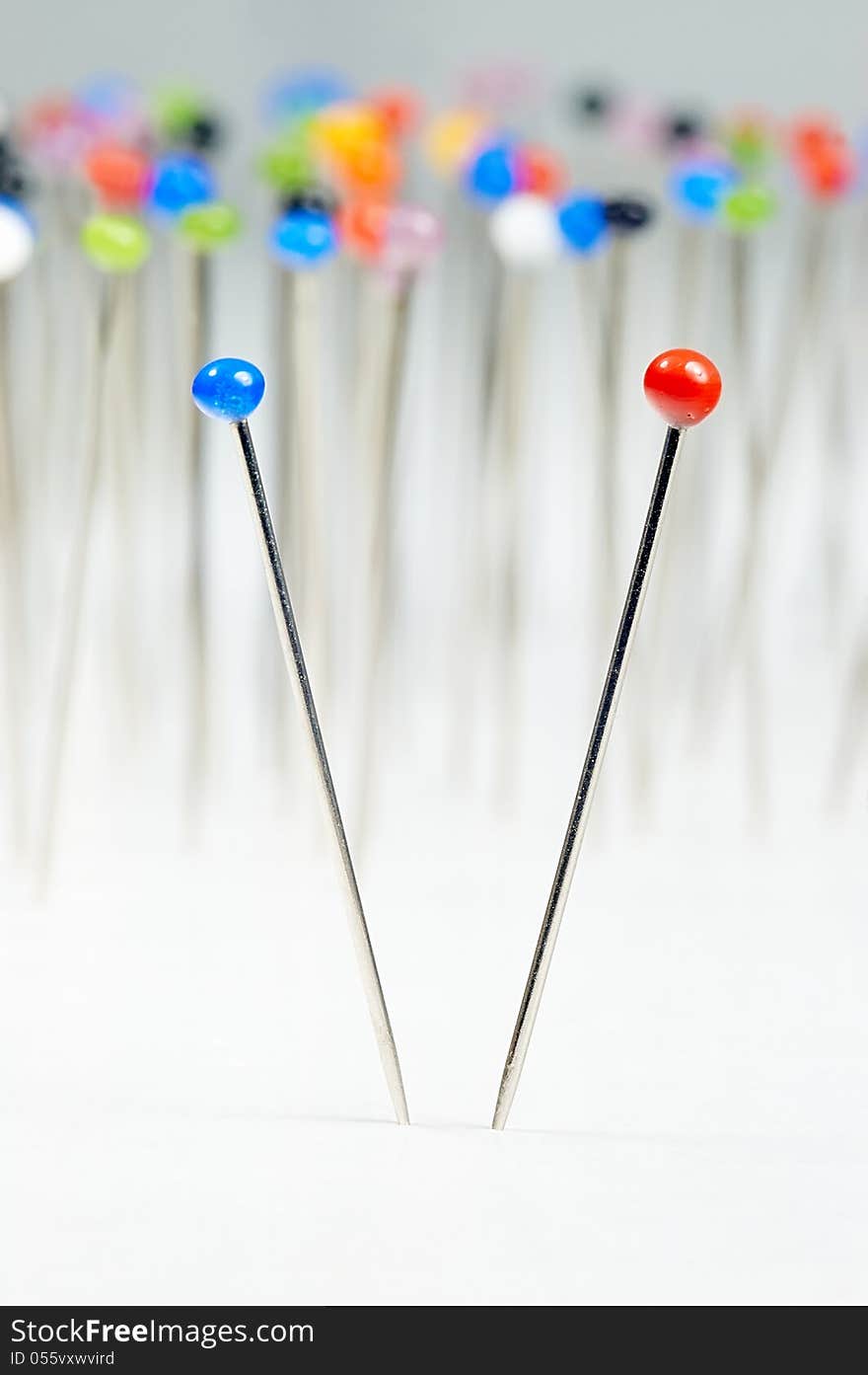 Different colored pins standing with background