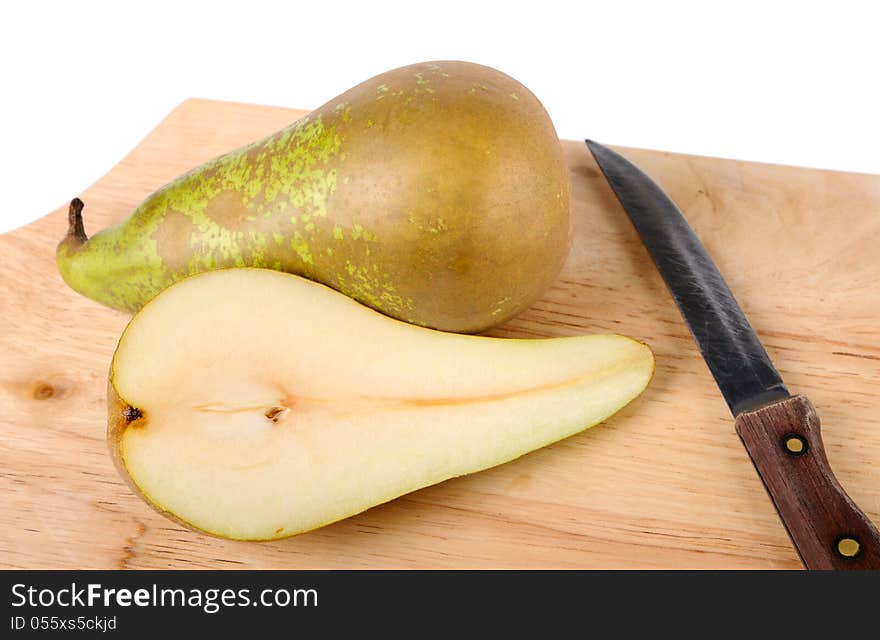 Pear, knife and chopping board closeup