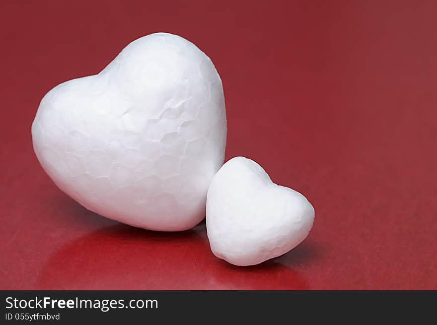 White hearts against a red background