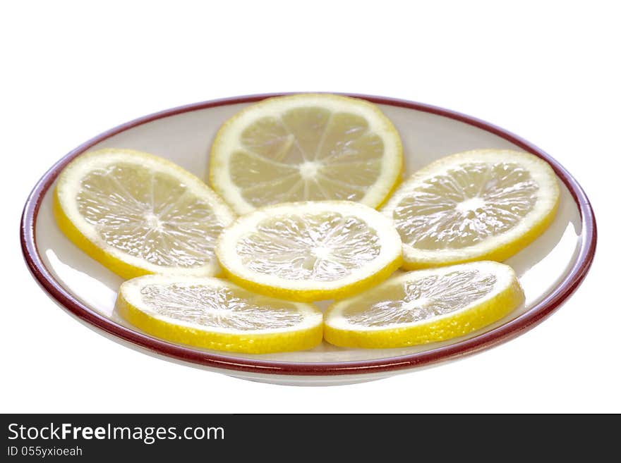 Lemons on a ceramic saucer, isolated on white background. Lemons on a ceramic saucer, isolated on white background