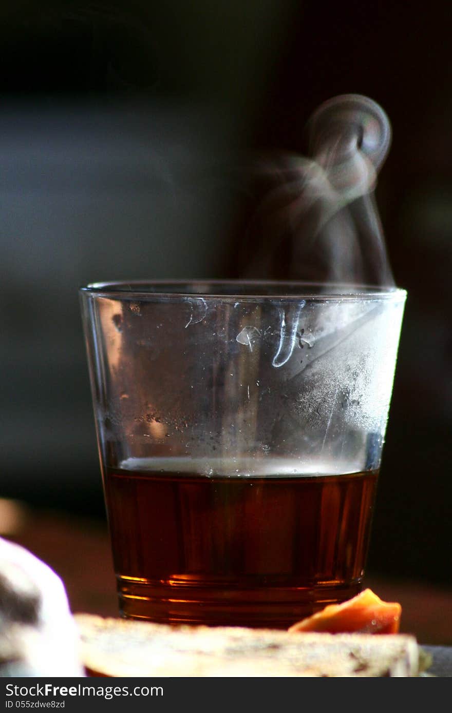 Steaming tea in a glass during the sunrise