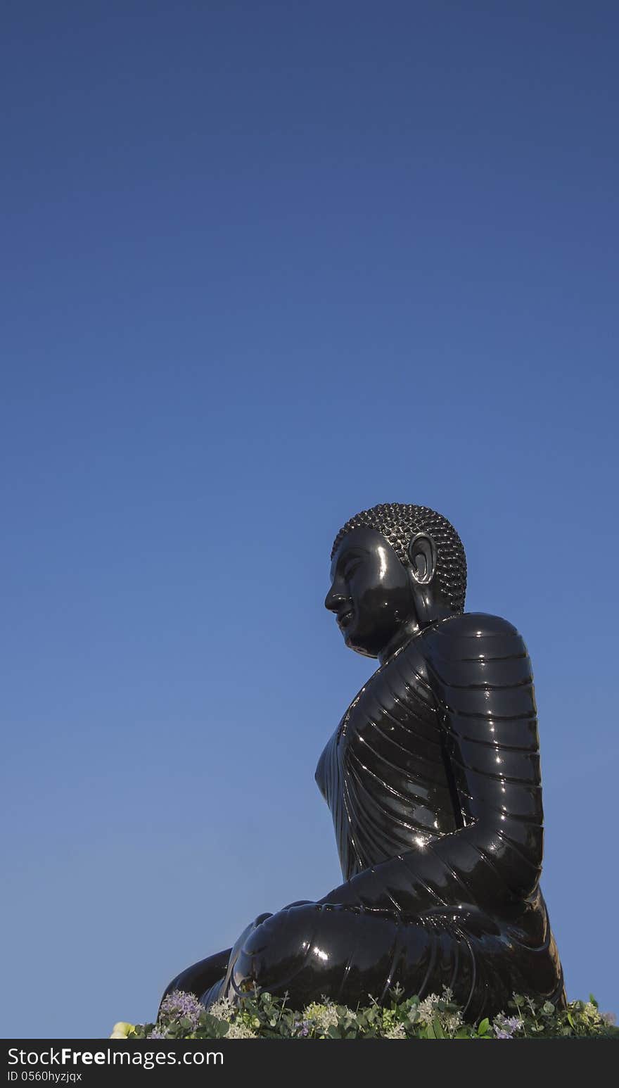 Buddha statue in blue sky background, black statue. Buddha statue in blue sky background, black statue