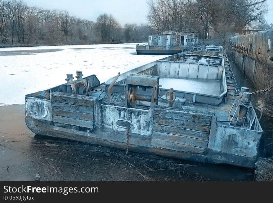 Old used ark in a frozen dock on the river. Old used ark in a frozen dock on the river