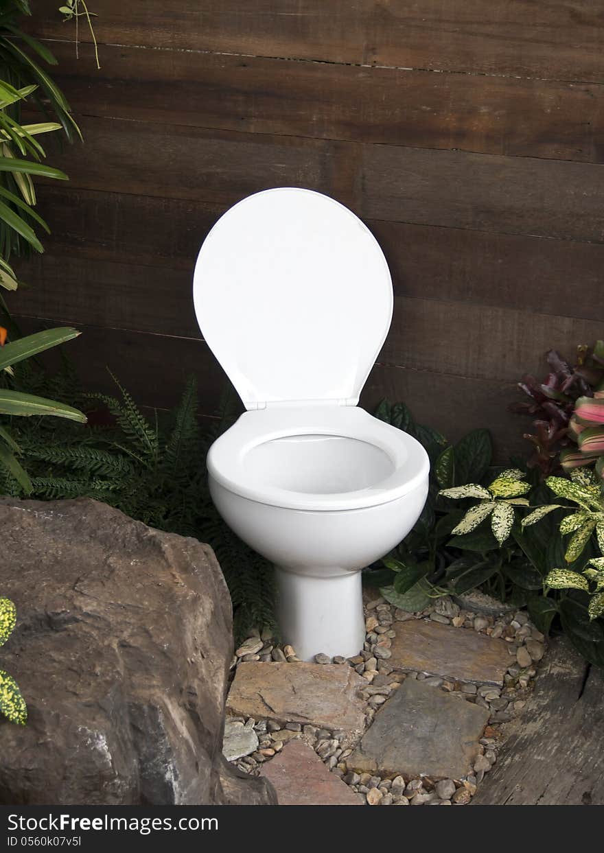 The white toilet in the garden. The white toilet in the garden