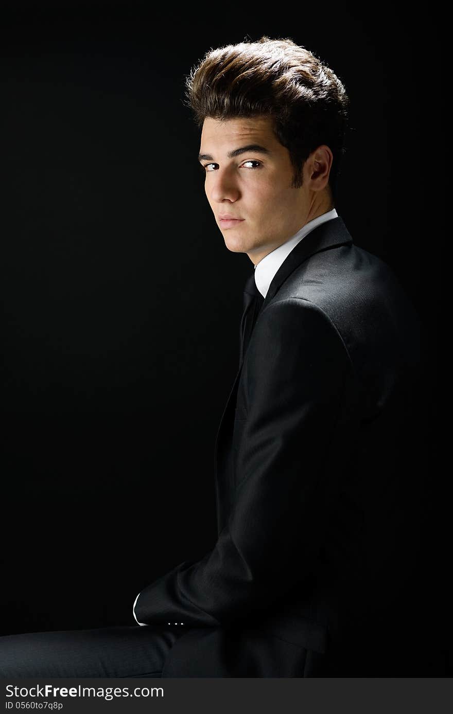 Young businessman, isolated on black background