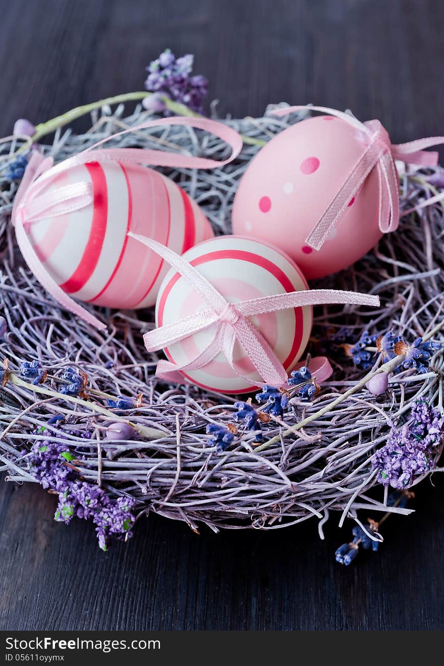 Colorful Easter eggs in a nest with flowers