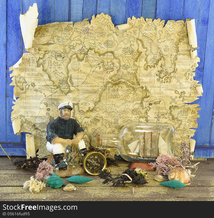 Composition with map, ship in glass and sea shells. Composition with map, ship in glass and sea shells