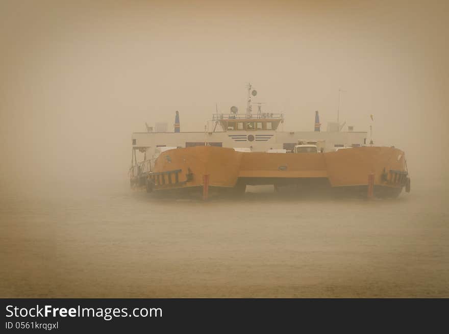 Car carrier ship in fog .