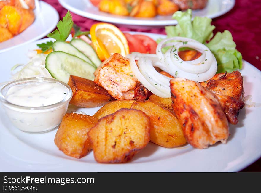 Grilled chicken steak, baked potatoes and vegetables