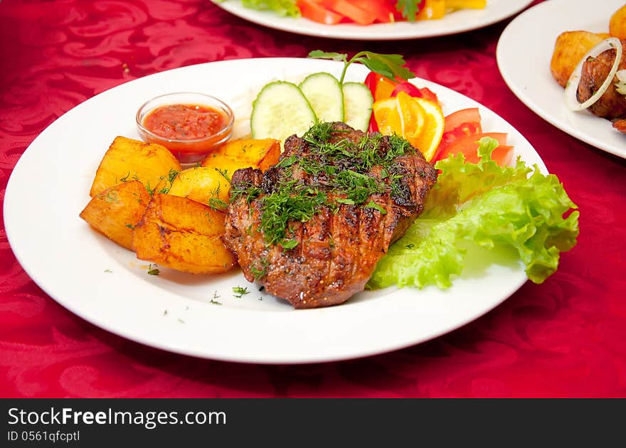 Grilled Beefsteak, Baked Potatoes And Vegetables