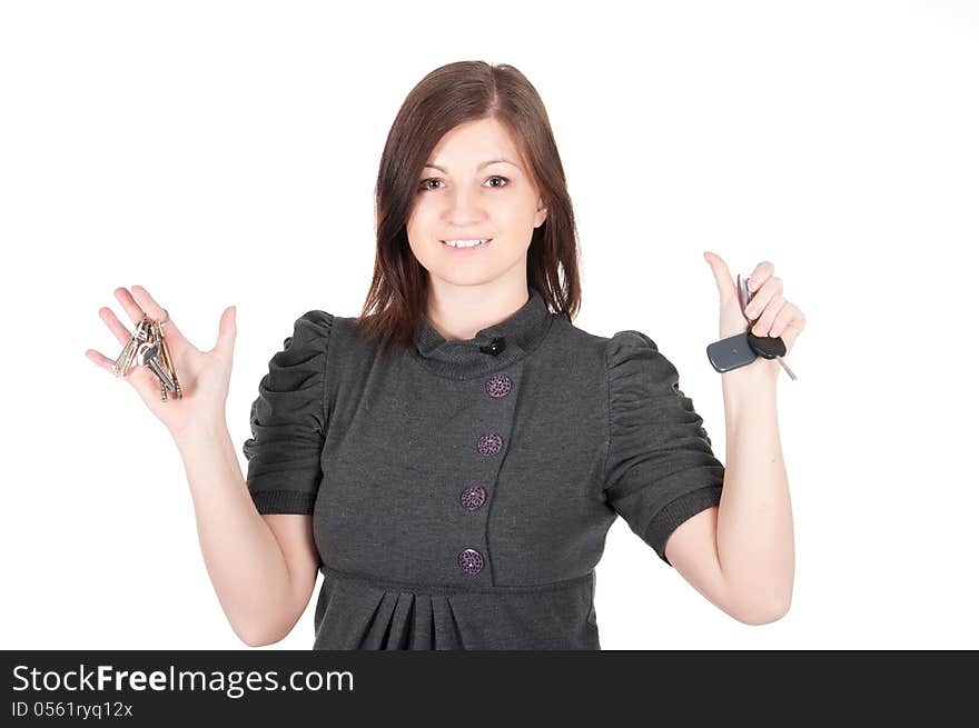 Young beautiful woman showing apartment keys on white background