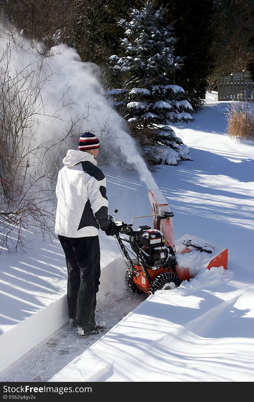 A man uses a snow blower to clear more than a foot of snow from a walkway in Ontario Canada after one of the biggest winter storms in years. A man uses a snow blower to clear more than a foot of snow from a walkway in Ontario Canada after one of the biggest winter storms in years.