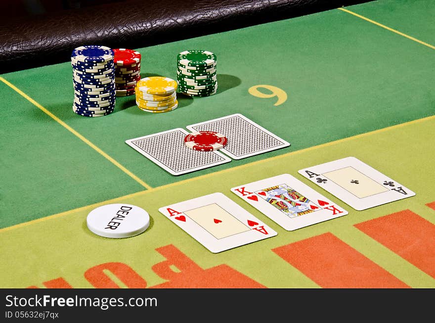 Poker cards and dealer button on the table.