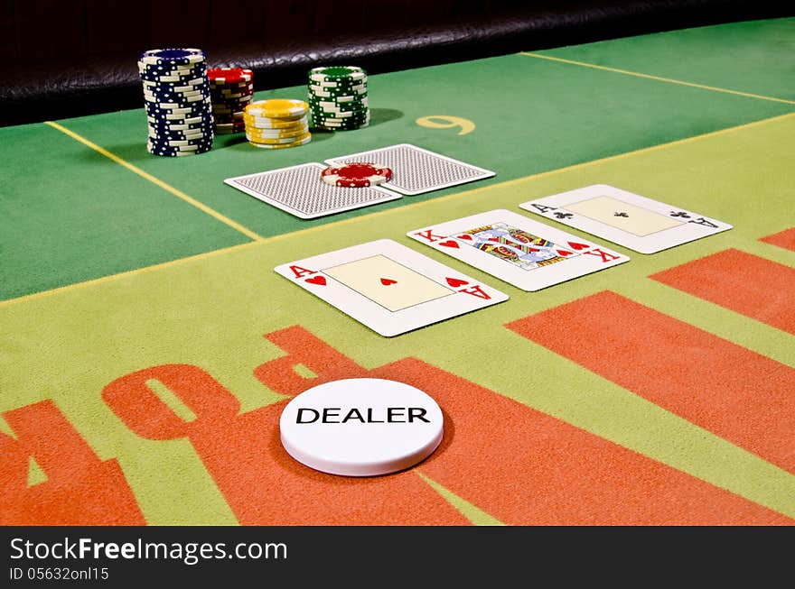 Poker cards and dealer button on the table.