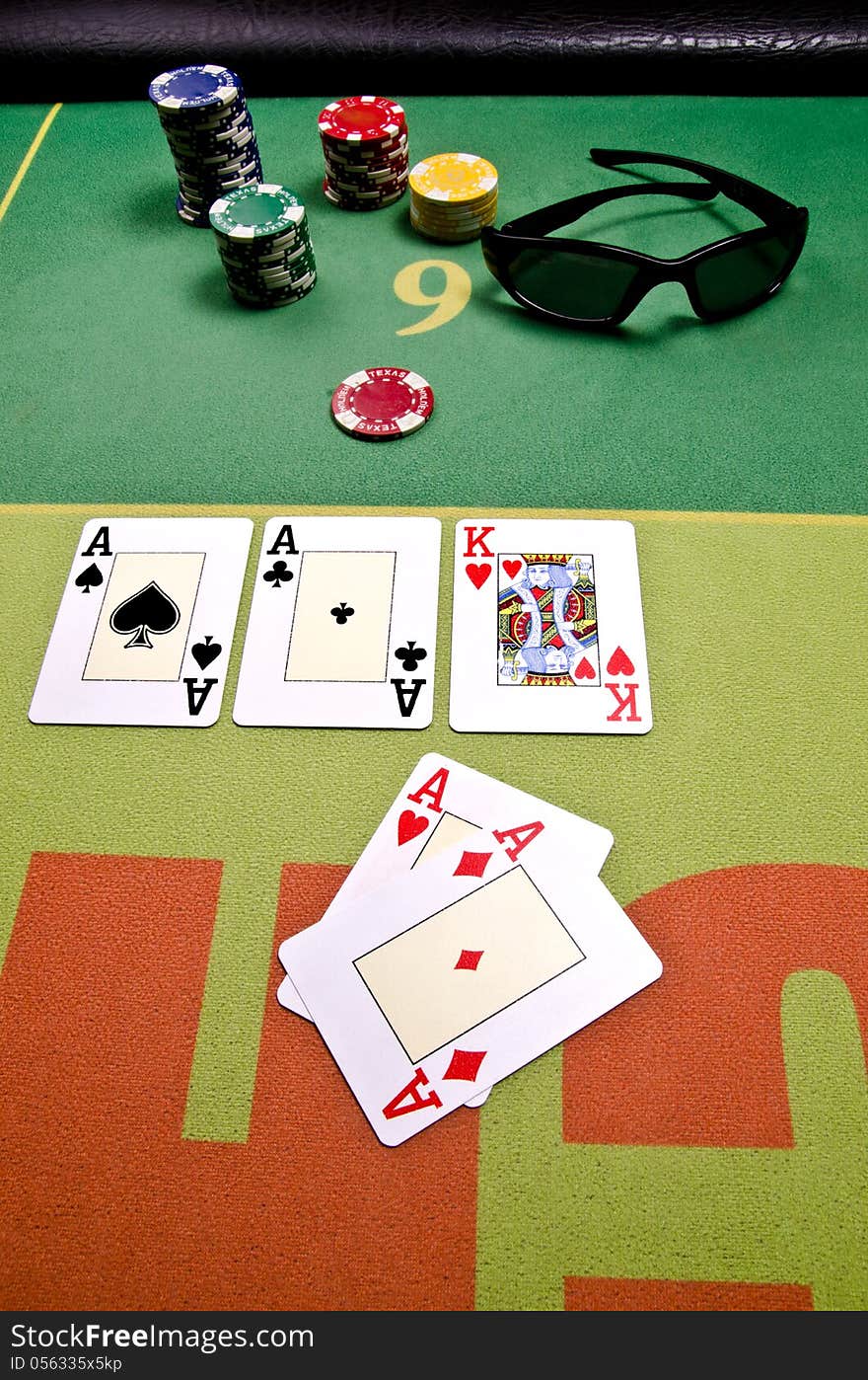 Poker cards and sunglass on the table.