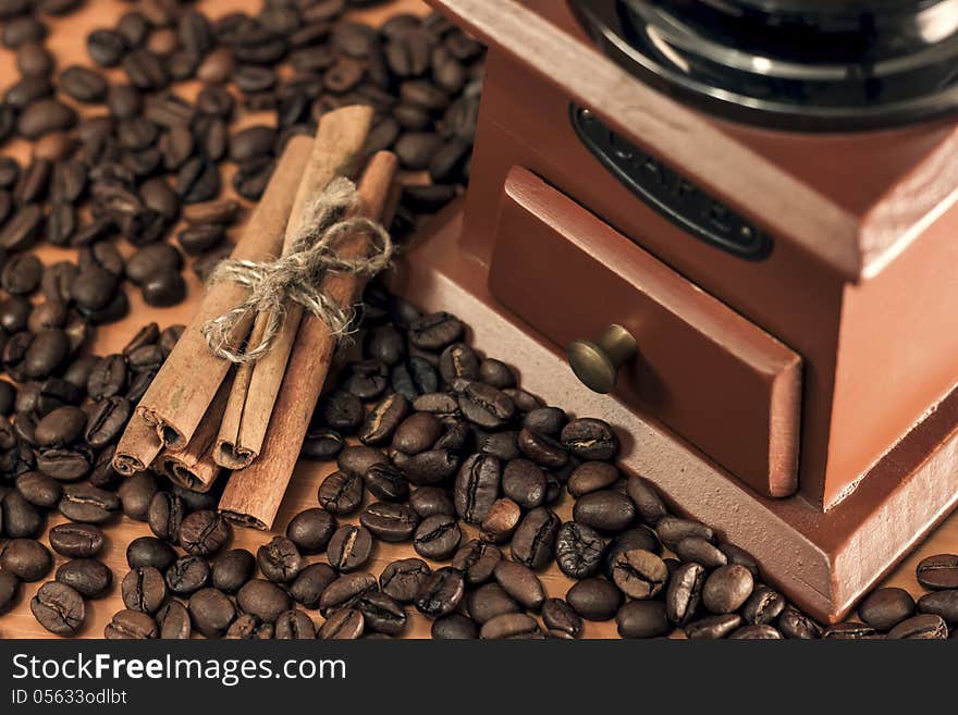 Coffee mill with cinnamon sticks and coffee grain