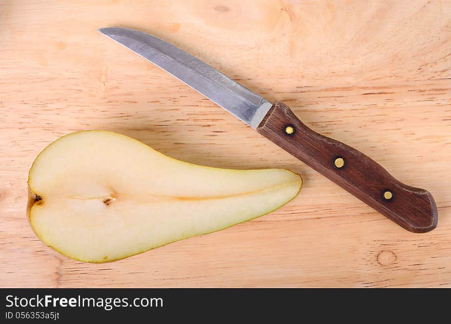 Half of a pear and knife