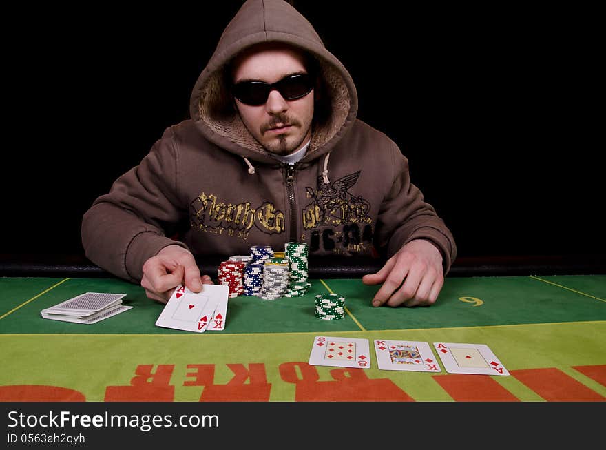 Poker player is showing his cards because he won. Poker player is showing his cards because he won.