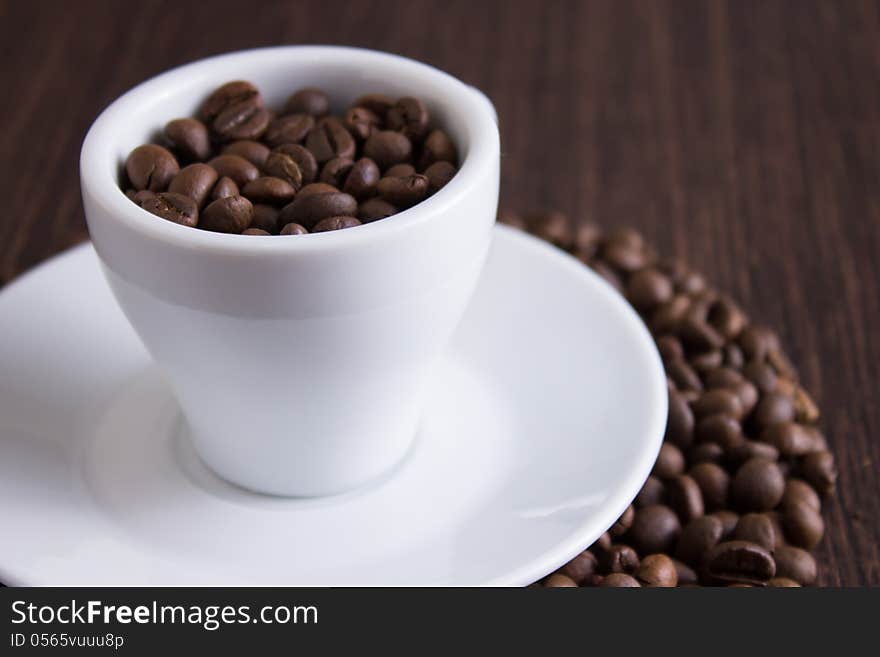 Coffee beans in white cup. Coffee beans in white cup