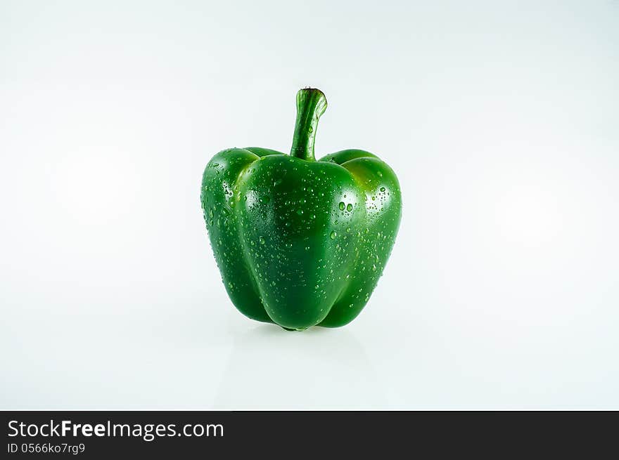 Green pepper with water splash isolated on white background