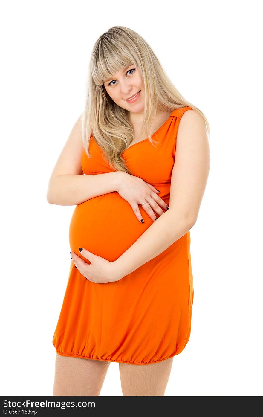 Pregnant girl in a dress stands