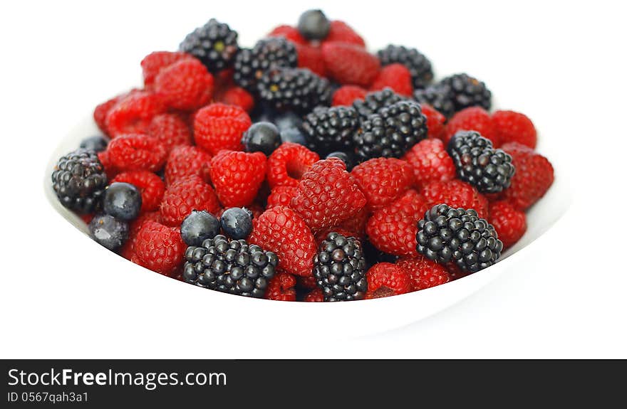 Raspberries, blackberries and blueberries on white background