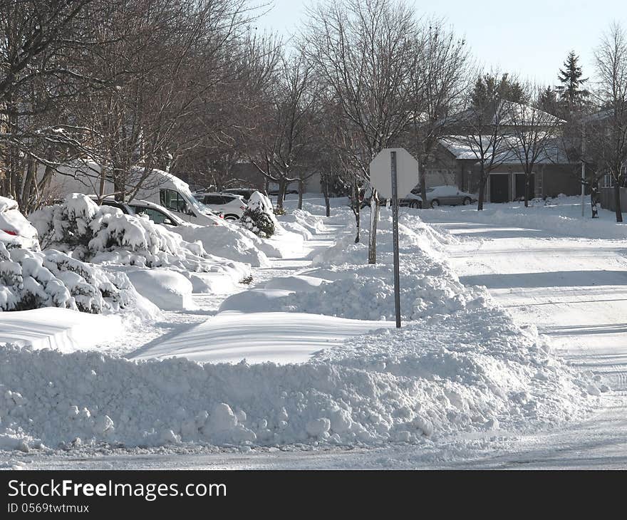 Sun shining on an urban city street after a heavy snowfall. Sun shining on an urban city street after a heavy snowfall.