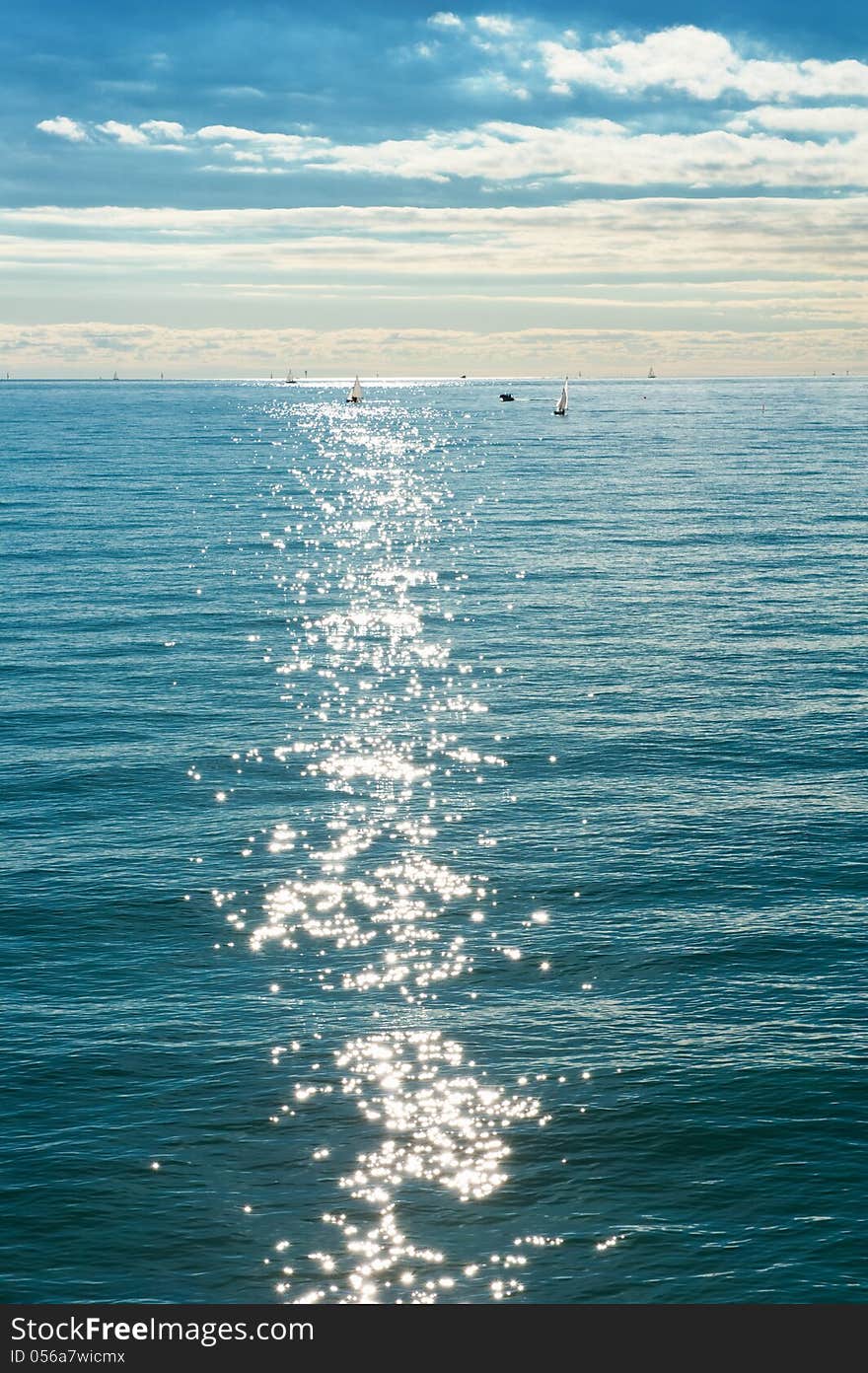 Beautiful sea landscape with boats and sun glare