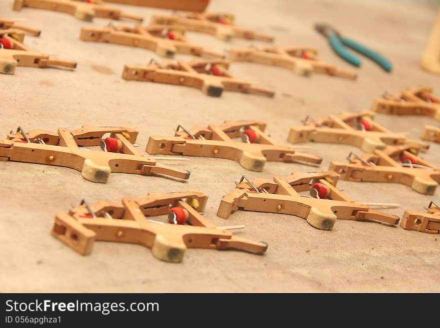 Piano hammers spaced out on a burlap sack being fixed.