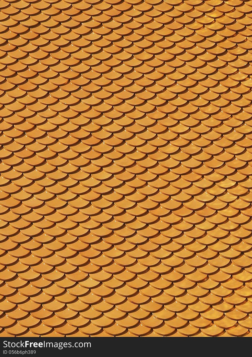 Pattern of yellow tile roof of thai temple