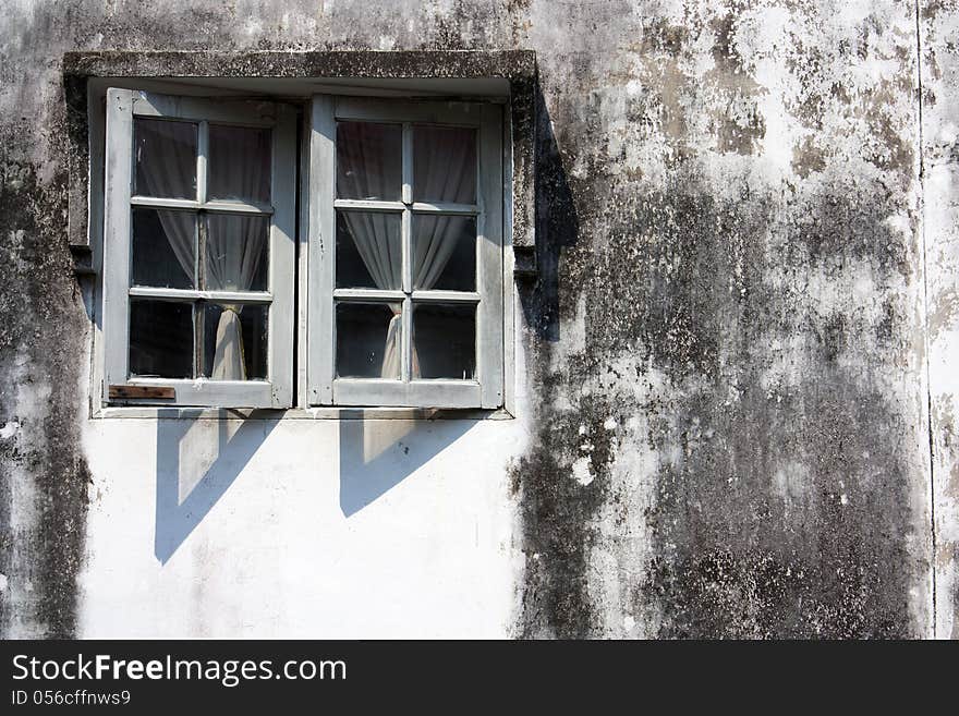 Exterior wall the window. Dirty old antique.