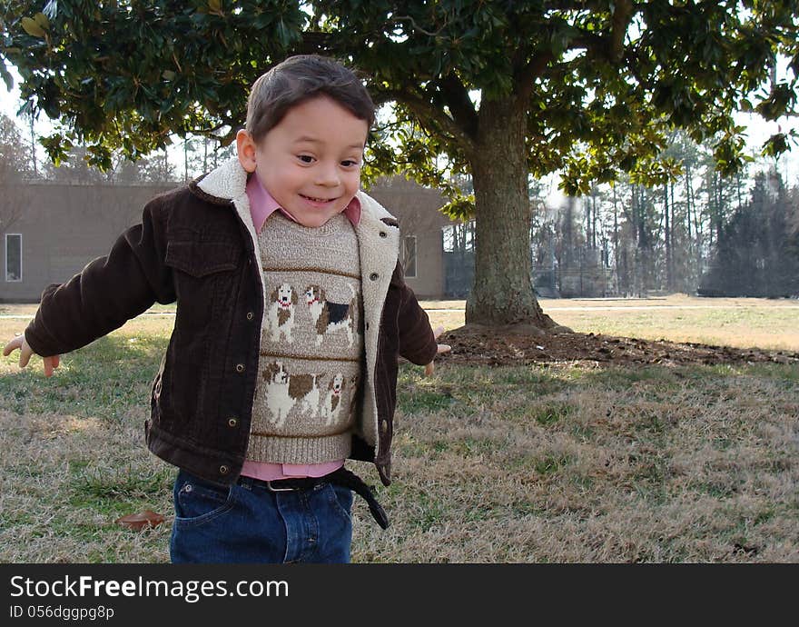 Cheerful little boy running around in excitement ready to jump. Cheerful little boy running around in excitement ready to jump