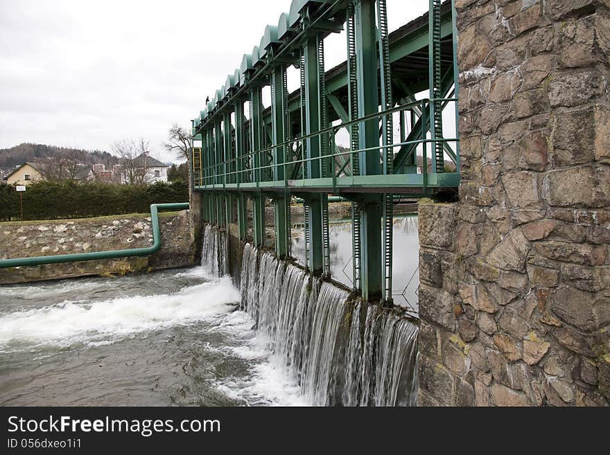 Green iron construction of the dam on the river