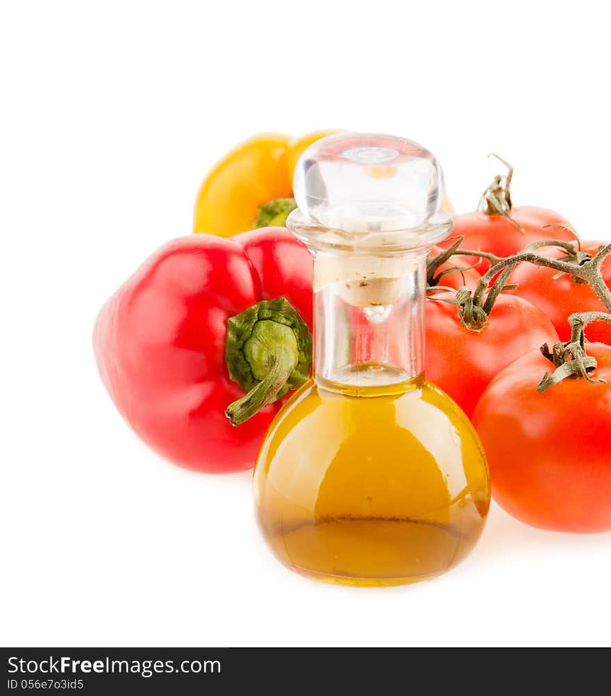 Bottle with olive oil ,tomatoes and peppers on a white background