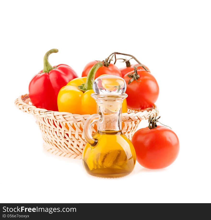 Bottle with olive oil on the background of the wattled dish with tomatoes and pepper on a white background