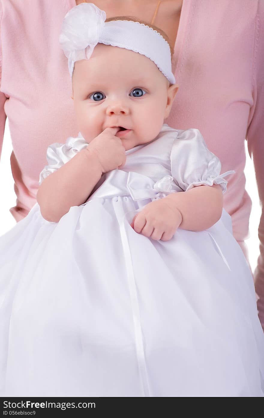 Newborn baby girl on mother hands in white dress