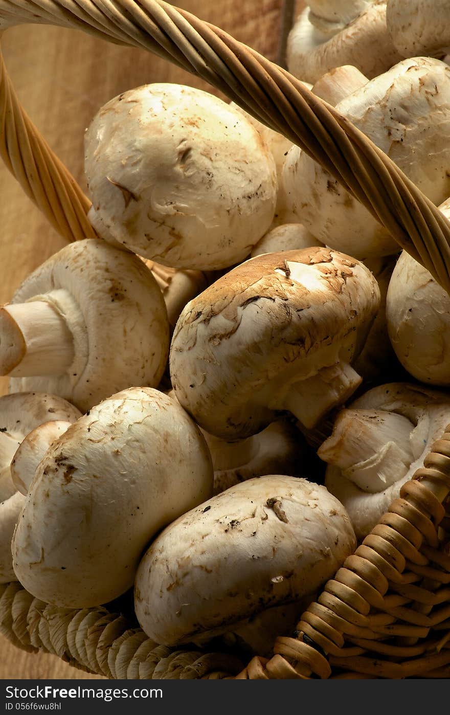 Basket of Perfect Big Raw Champignons Cross Section on Wooden background. Basket of Perfect Big Raw Champignons Cross Section on Wooden background