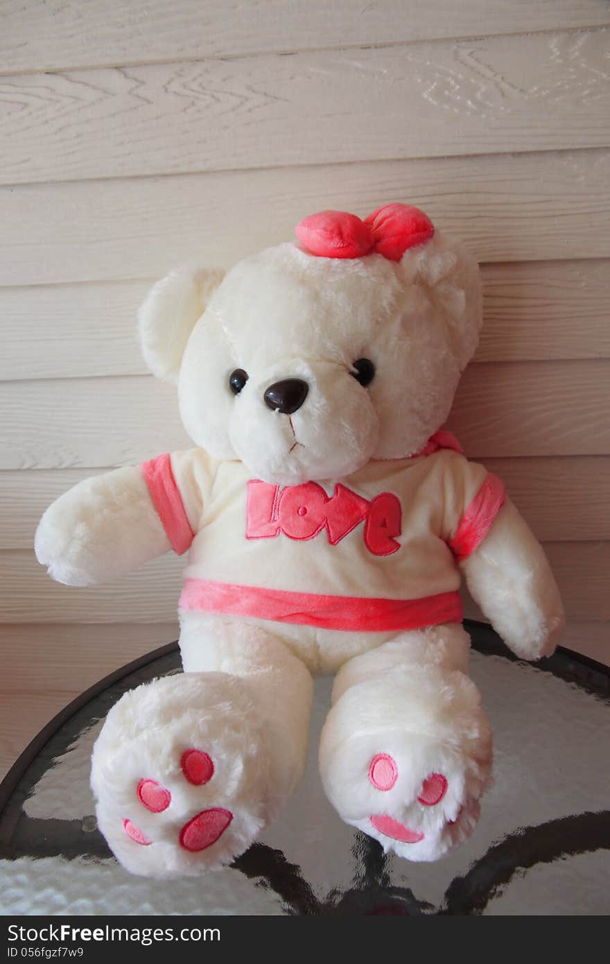 White teddy bear have a Pink ribbon. White teddy bear have a Pink ribbon.