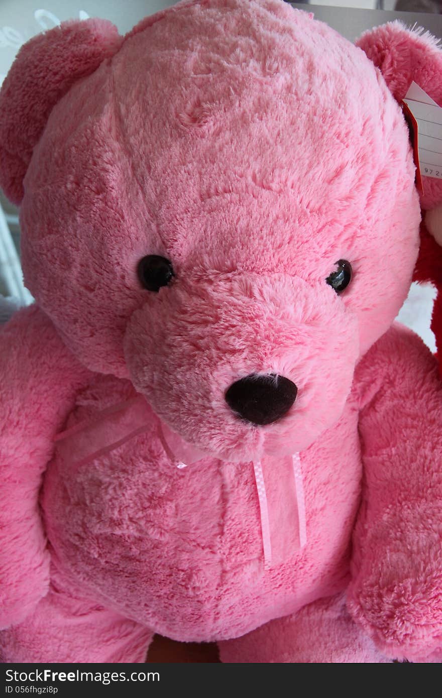 Pink teddy bear have a black eye. Pink teddy bear have a black eye.