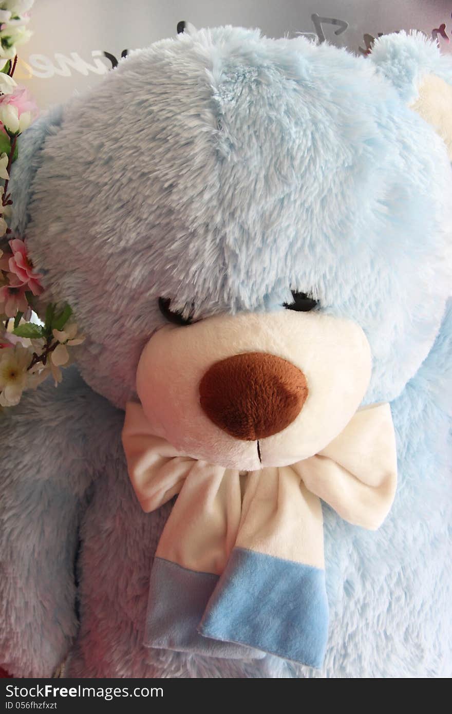 Sky blue teddy bear have a black eye. Sky blue teddy bear have a black eye.