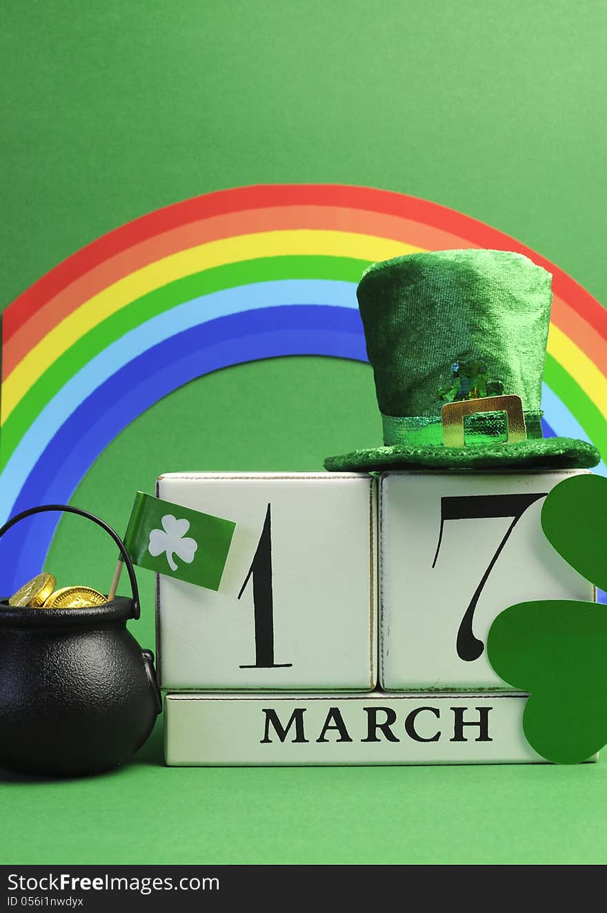 Save the date white block calendar for St Patrick's Day, March 17, with Leprechaun hat, pot of gold, and rainbow, on green background. Save the date white block calendar for St Patrick's Day, March 17, with Leprechaun hat, pot of gold, and rainbow, on green background.