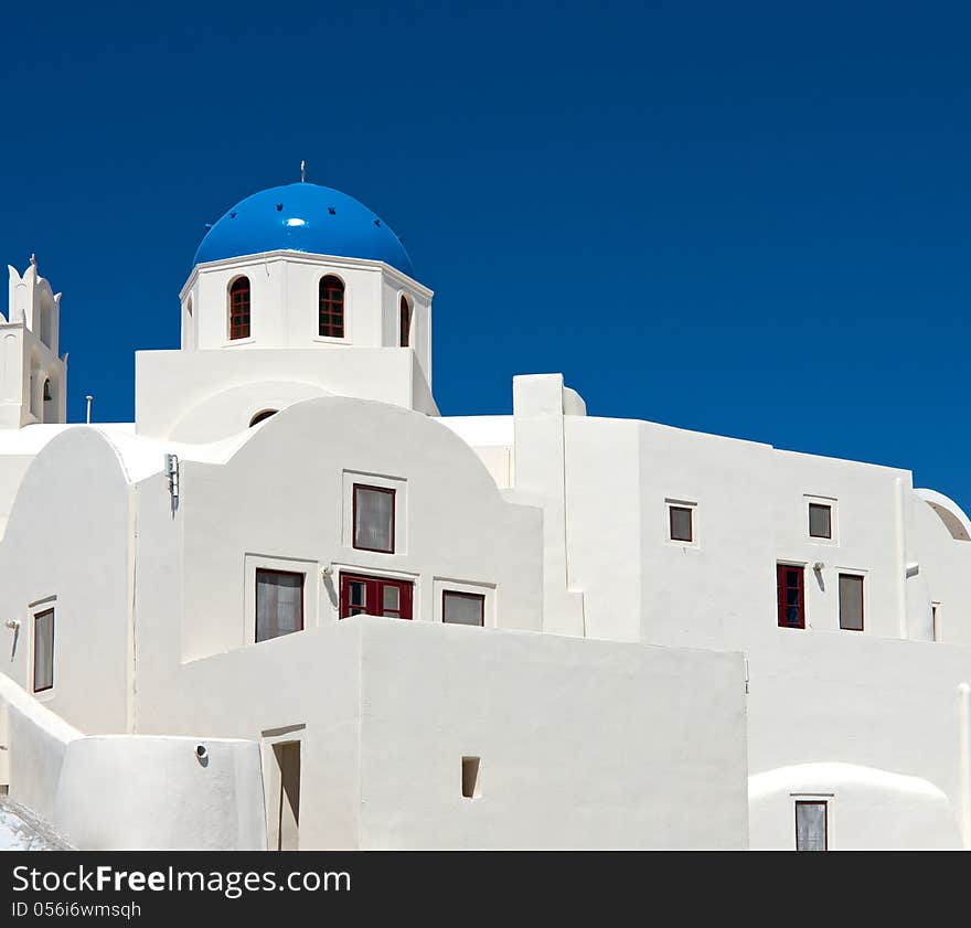 White walls of the city's buildings are decorated with blue domes. Their color competes with the color of the sky. White walls of the city's buildings are decorated with blue domes. Their color competes with the color of the sky.